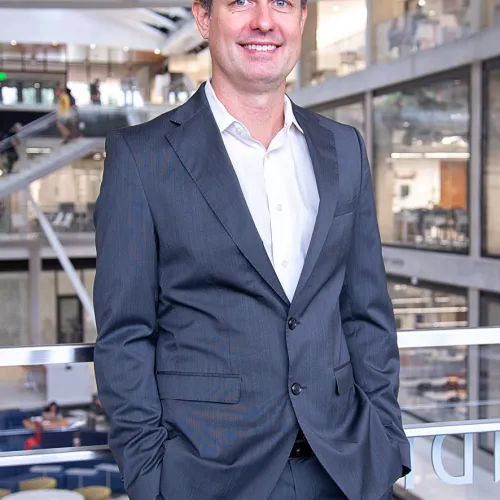 A man in a suit standing in an office.